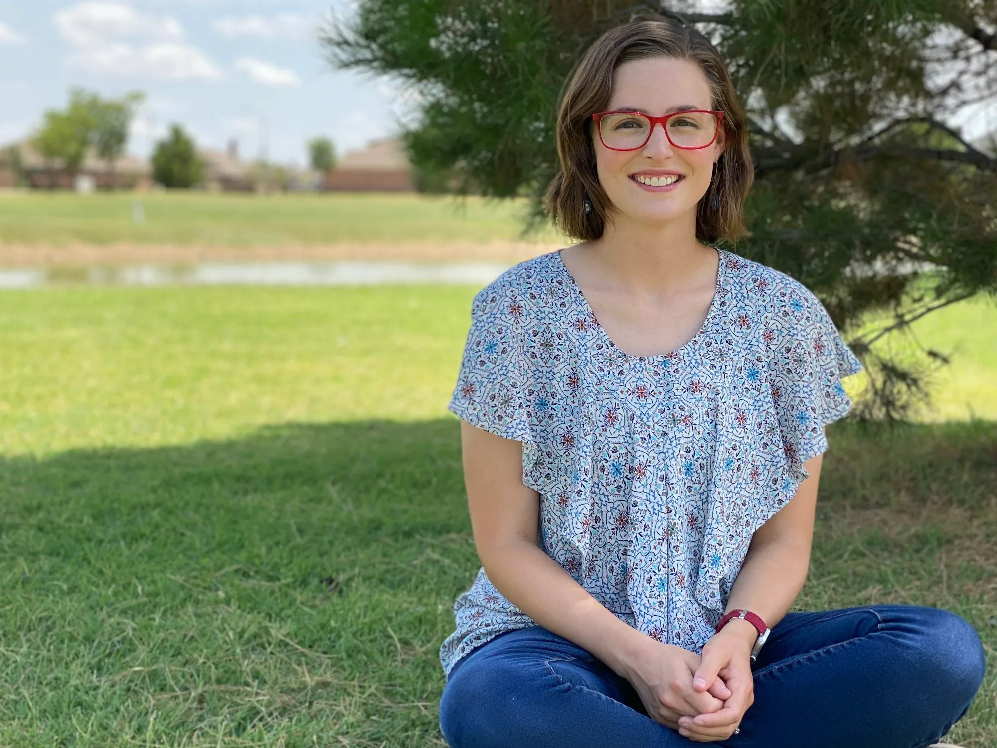 Kelsey Brewer seated outdoors